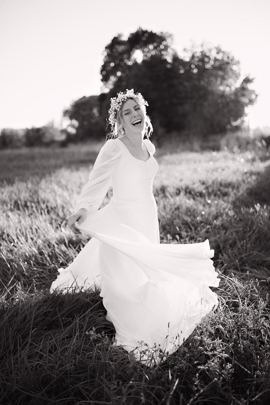 Freebie Lightroom Presets and Lightroom Profiles Free used to edit the image of a bride laughing in black and white.