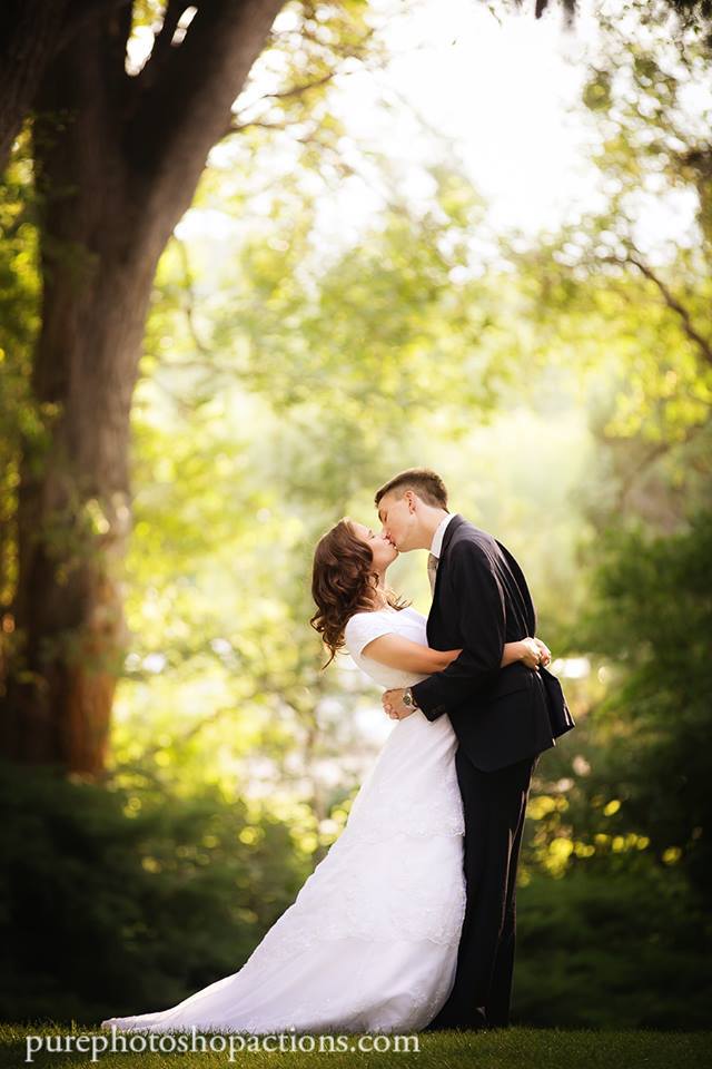 An image of a bride and groom kissing in a forrest edited using Pure Essential Edit Photoshop Actions and Lightroom Presets.