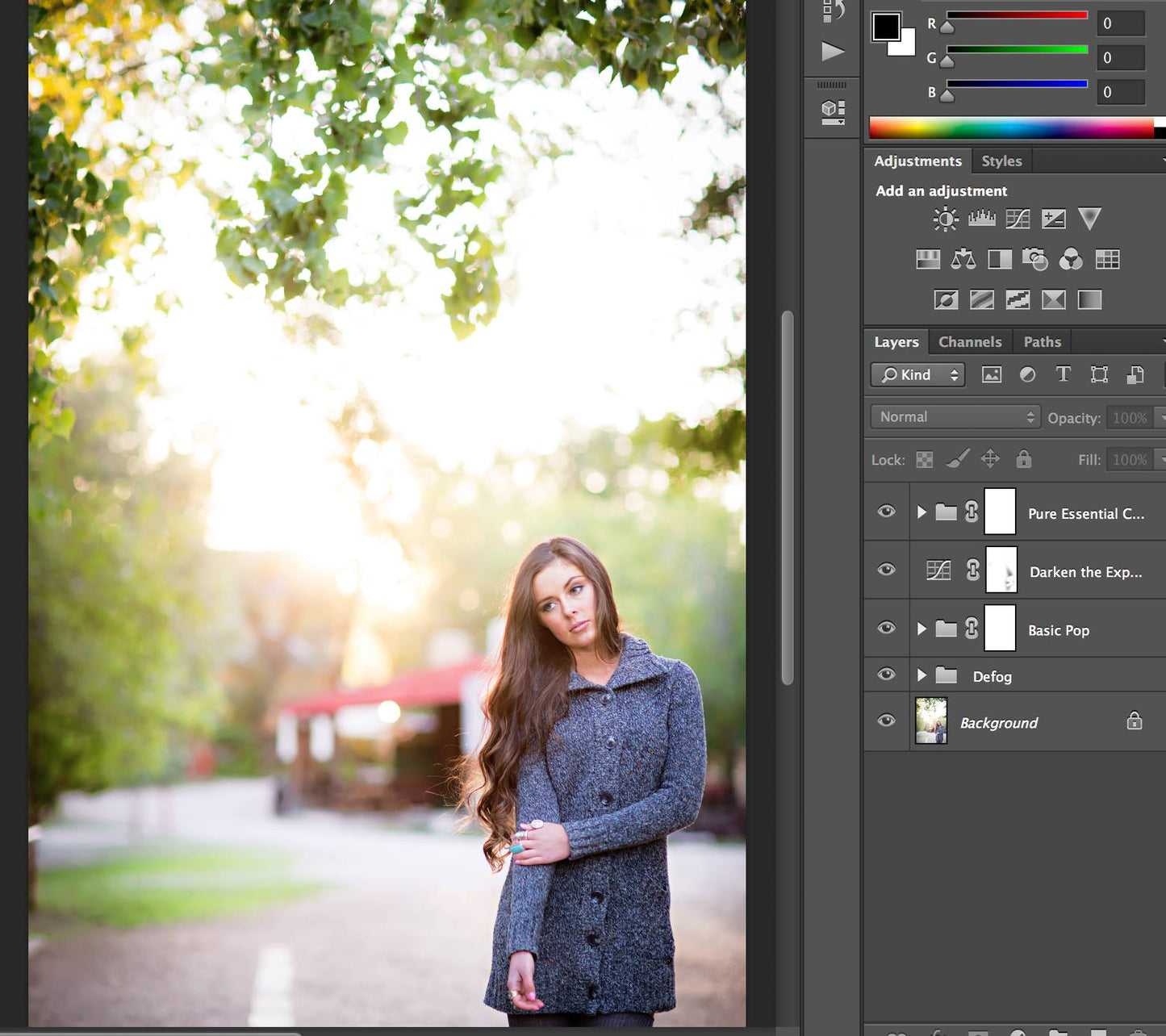 An image of a young woman standing at a farm open in Photoshop with a layers palette visible showing an edit using Pure Essential Edit Photoshop Actions.