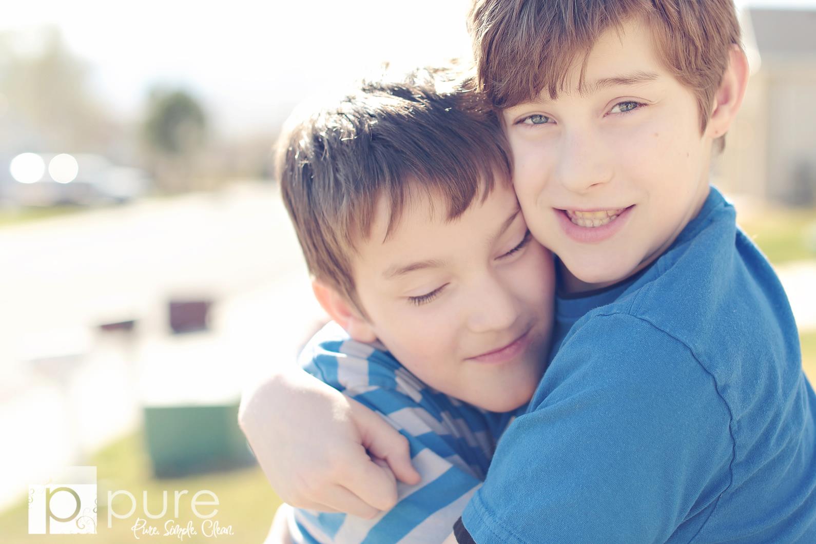 Two brothers hugging with a vintage tone to the image demonstrating the effects of the Purely Vintage Photoshop Action set.