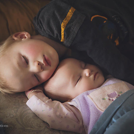 A image of a baby brother and sister asleep edited using Pure Artistic Matte Photoshop Actions.