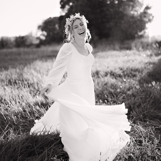 Freebie Lightroom Presets and Lightroom Profiles Free used to edit the image of a bride laughing in black and white.