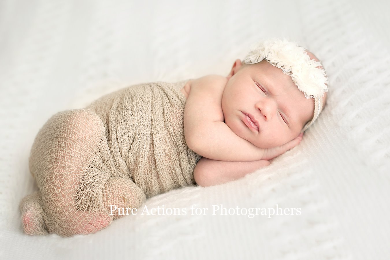 An image of a newborn baby on a white blanket edited using Pure Essential Edit Photoshop Actions and Lightroom Presets.