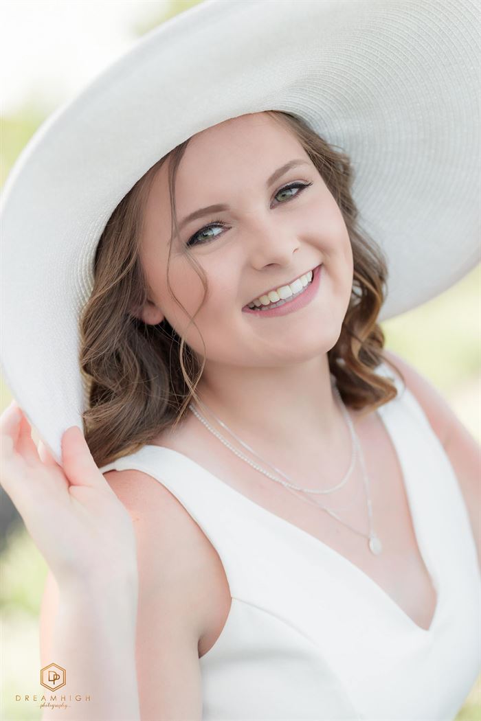 An after image of a young woman in a white hat edited using the Pure Soft and Airy Photoshop Actions and Lightroom Preset set.