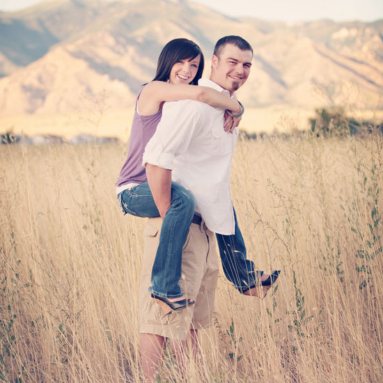 A Vintage toned image of a couple in a dreamy mountain and fieldl location edited using Purely Vintage Photoshop Actions.
