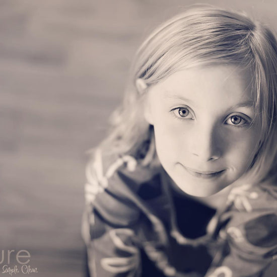 A black and white image of a young girl with a cool brown pink vintage tone from the Purely Vintage Photoshop Action Set.