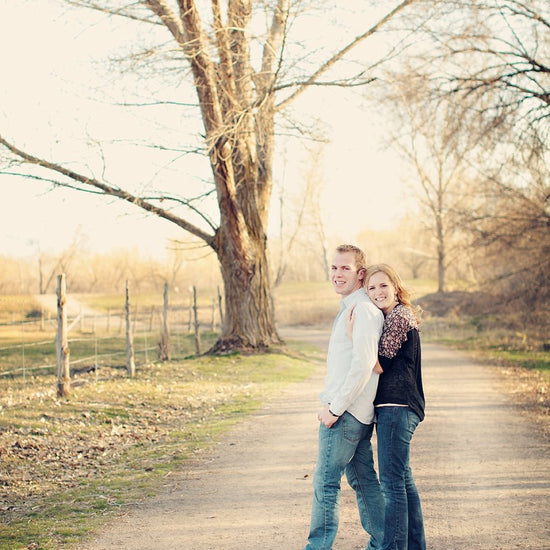 A Vintage toned image of a couple in a dreamy country road location edited using Purely Vintage Photoshop Actions.