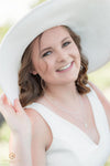 An after image of a woman in a large white hat and dress showcasing the effects of the Pure Soft and Airy Lightroom Presets set.
